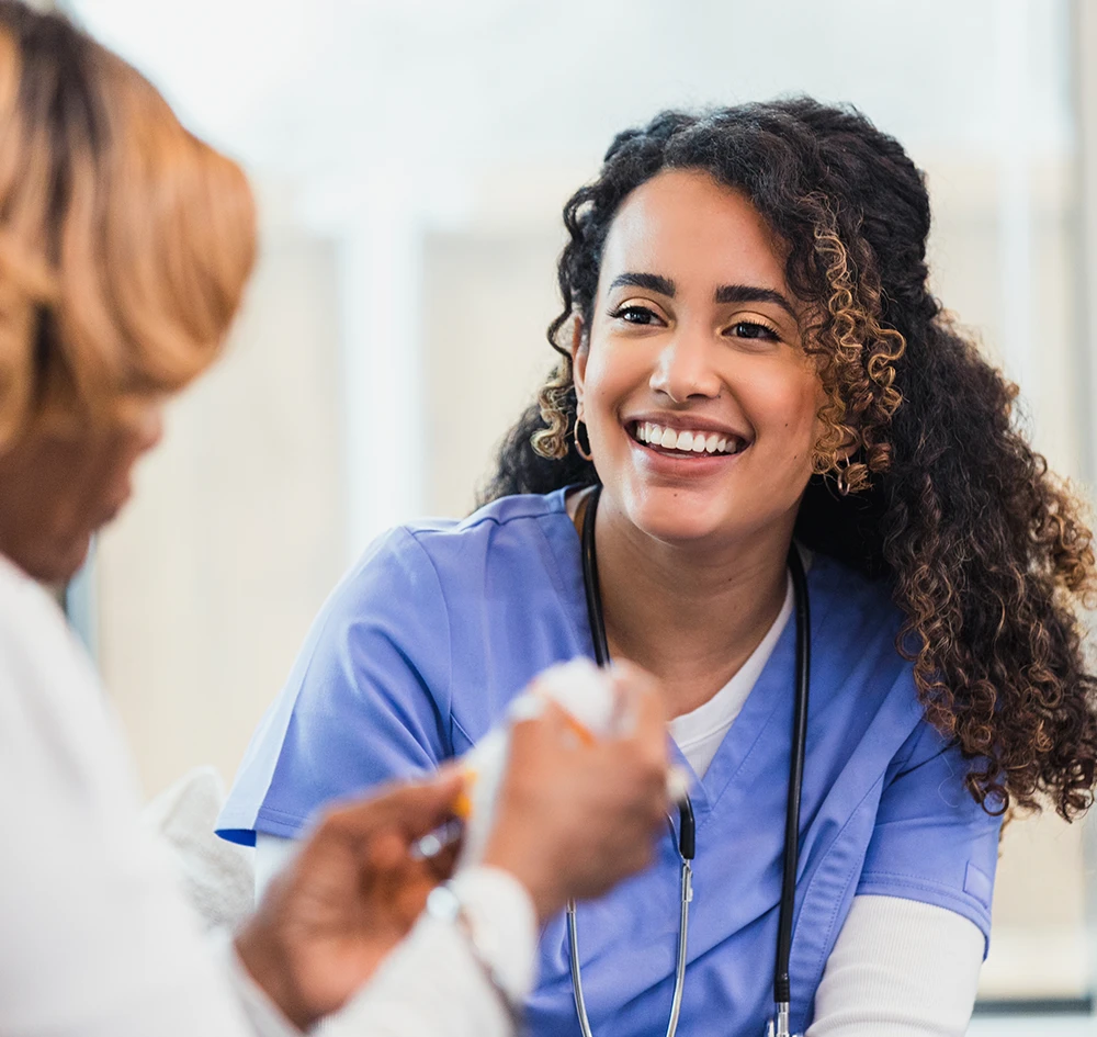 A professionally staffed doctor conducting a one-on-one patient consultation, delivering trusted clinical care in a modern healthcare setting